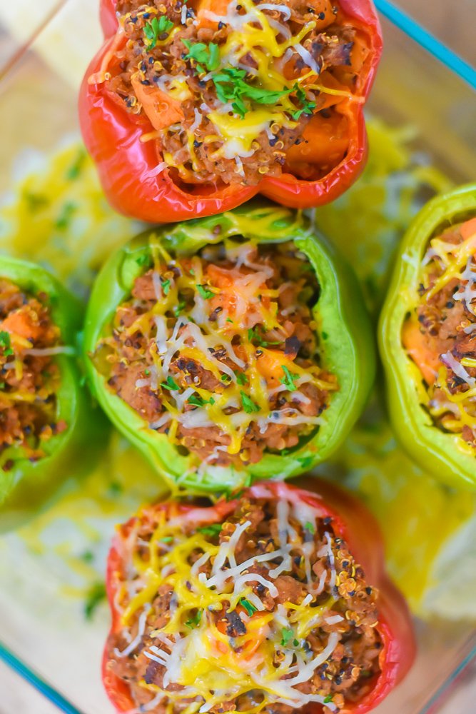 red and green stuffed bell peppers with melted cheese on top