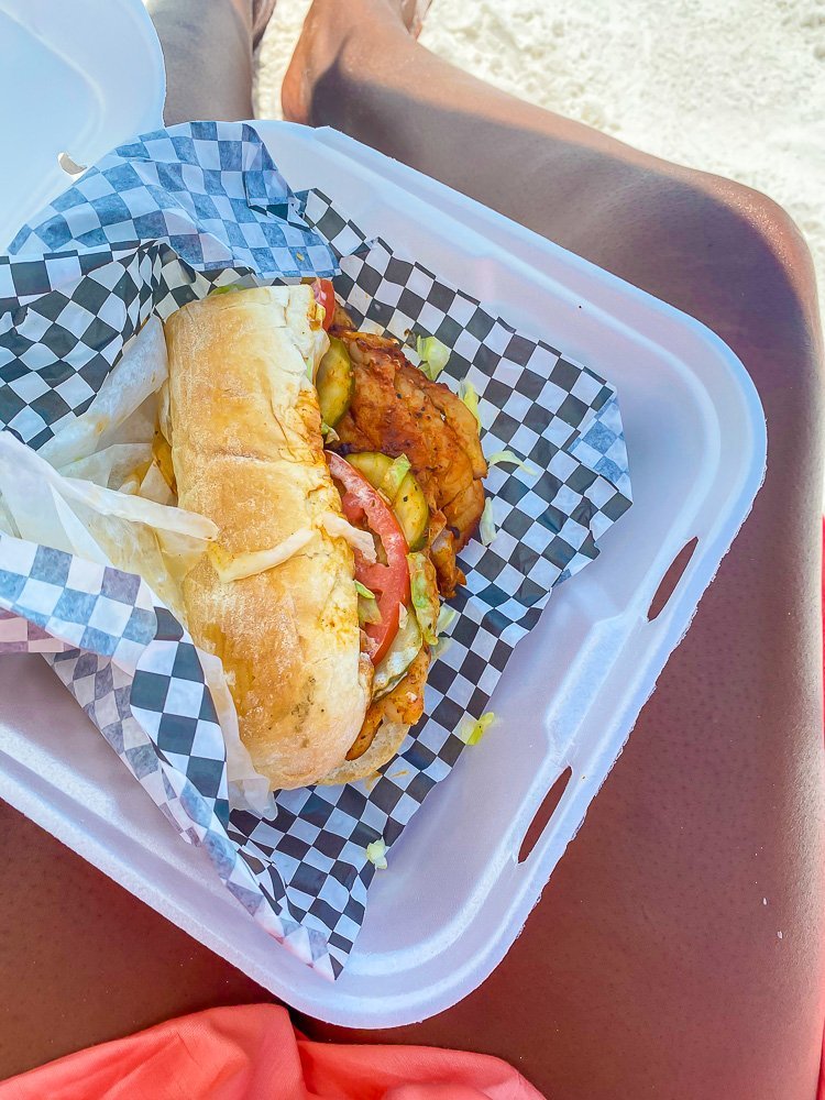 blackened grouper po boy in styrofoam to-go container