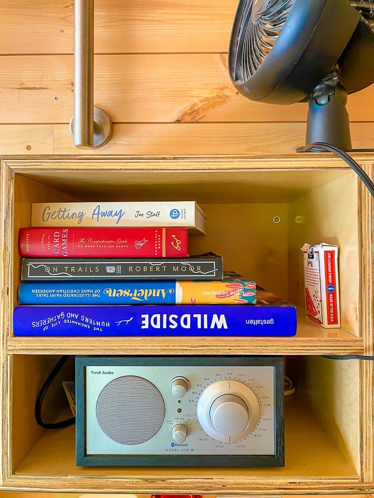books, games, and radio on shelf in Getaway cabin