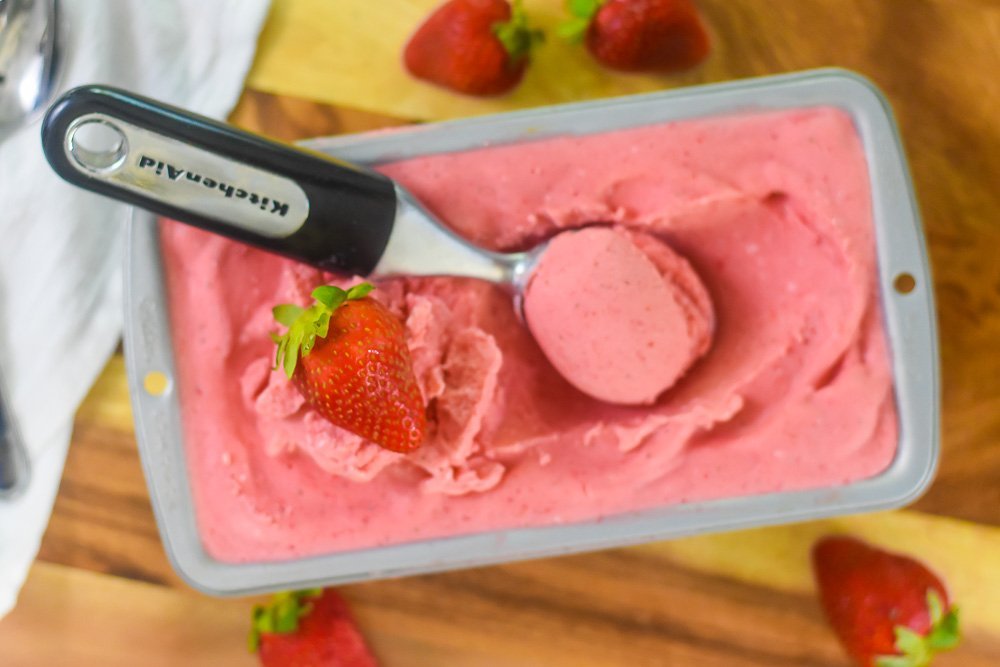 scoop of homemade strawberry ice cream in pan.