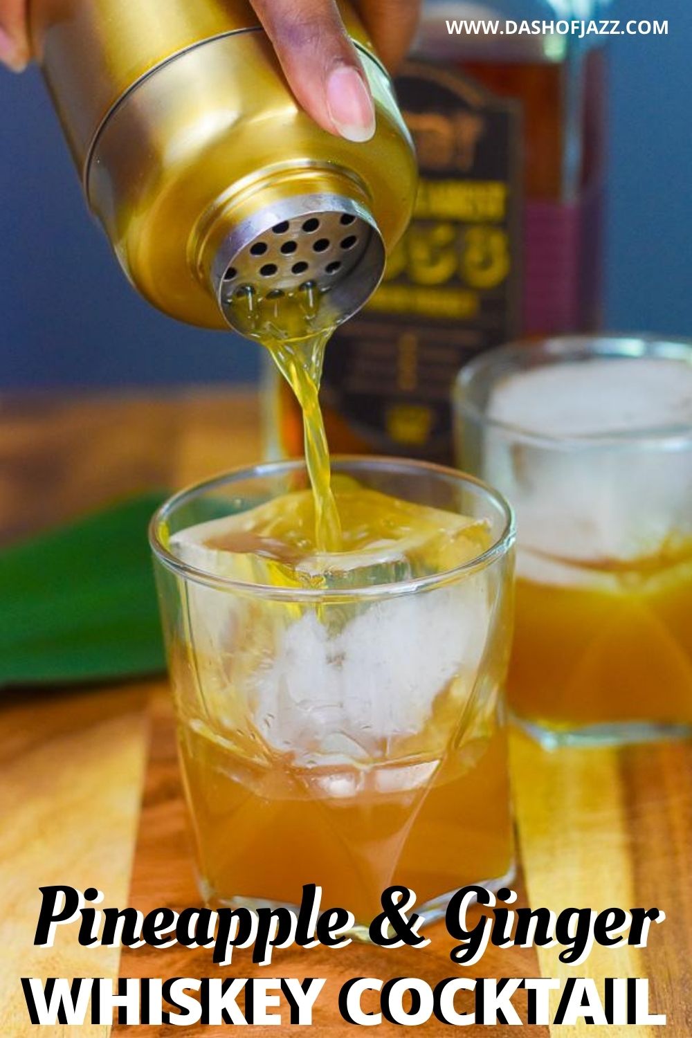 pouring whiskey cocktail into glass with text overlay "pineapple & ginger whiskey cocktail"