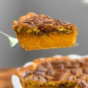 side view of slice of bourbon sweet potato pecan pie