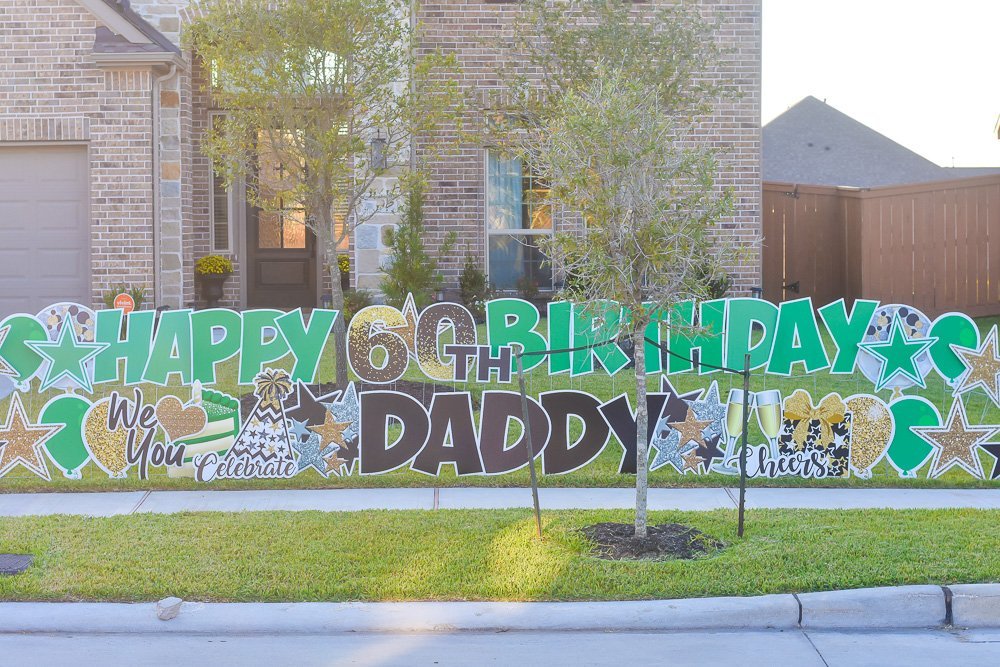 green, black, and gold front yard greeting sign reading "Happy 60th Birthday Daddy"