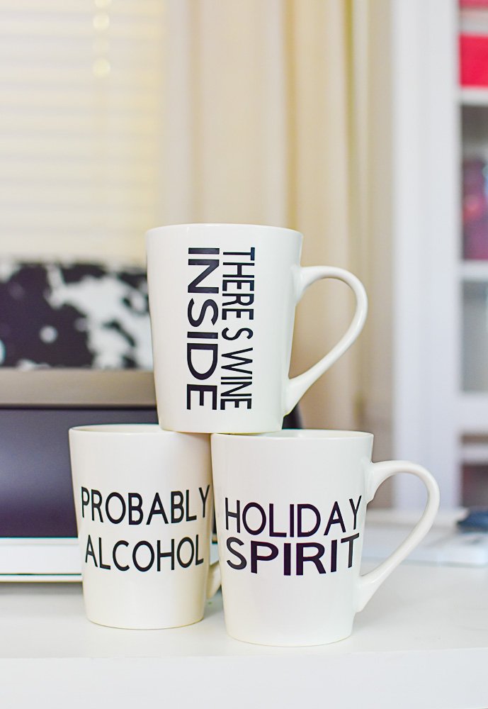 three mugs stacked on each other on desk with cocktail-themed sayings