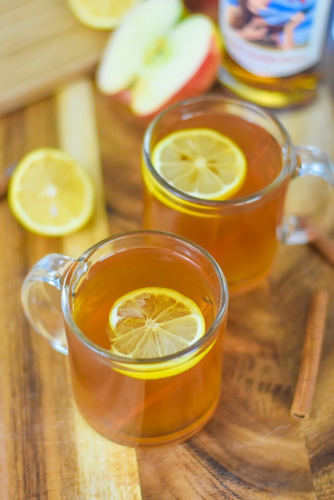 two spiced apple cider hot toddies in mugs