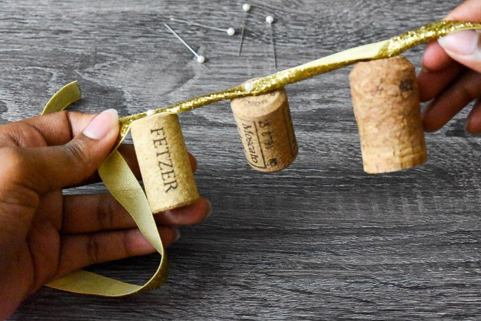 holding homemade wine cork garland