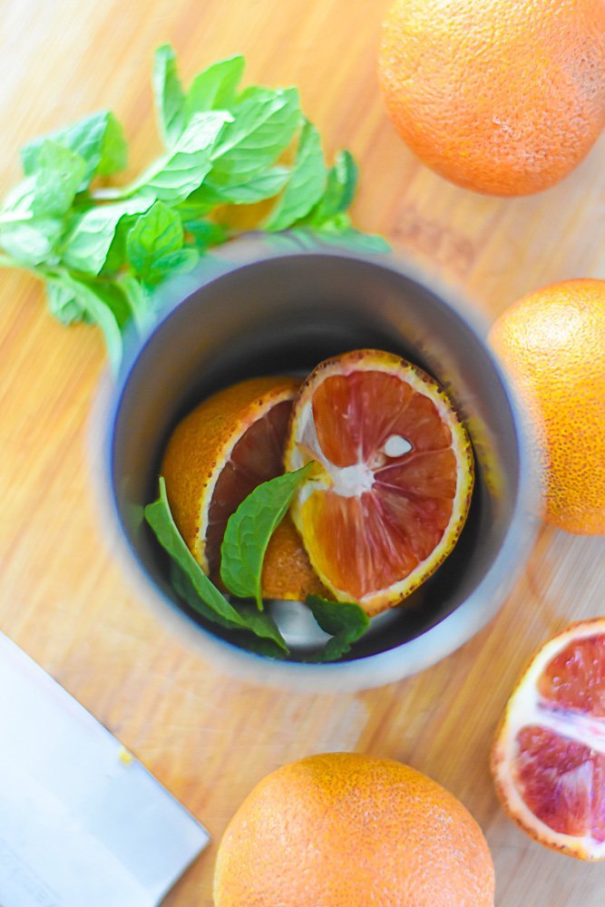 blood orange segments and mint leaves in cocktail shaker.