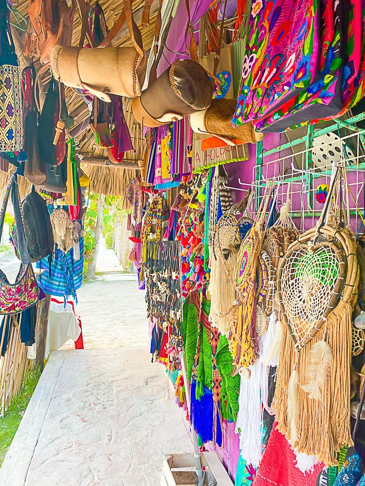 colorful hanging bags, weavings, and other crafts in souvenir shop