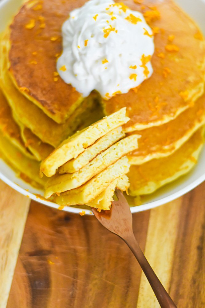 stack of mimosa pancakes on fork.