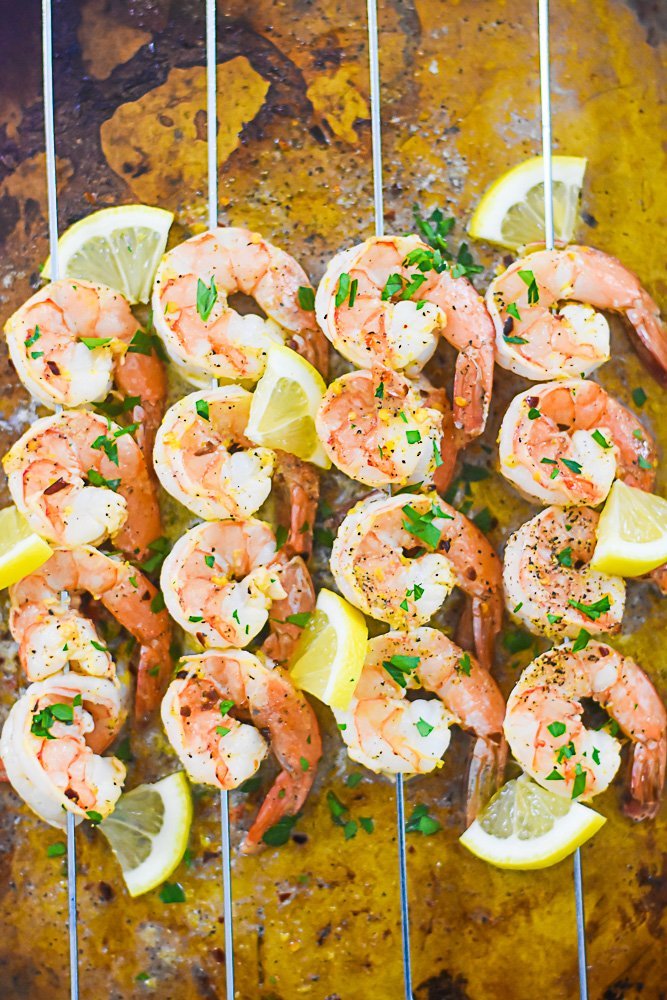 lemon pepper shrimp skewers on a sheet pan.