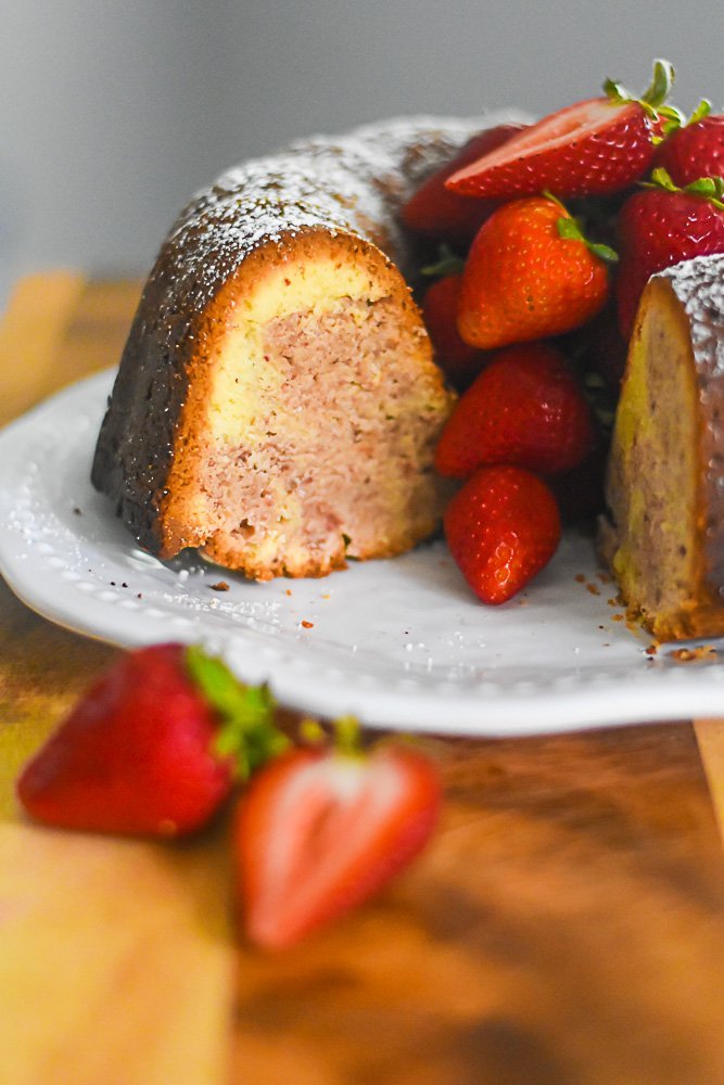 strawberry swirled pound cake garnished with fresh berries.
