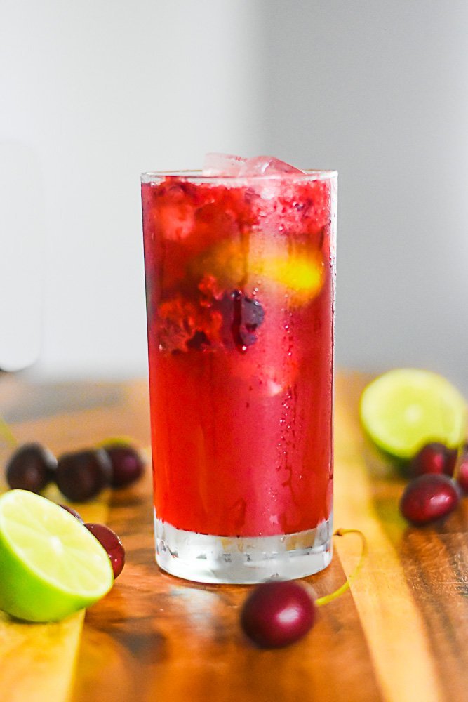 glass of cherry limeade spiked with bourbon.