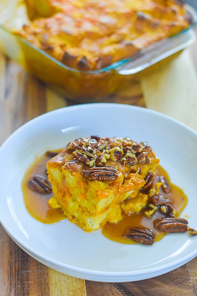 piece of sweet potato bread pudding with praline sauce and pecans.