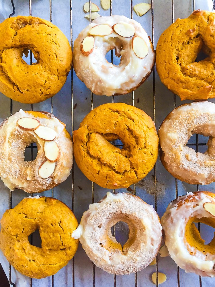 decorated pumpkin cake donuts on cooling wire rack.
