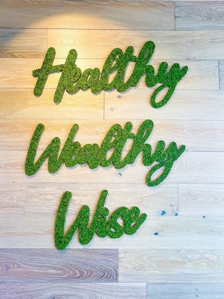 green sign that reads "Healthy Wealthy Wise".