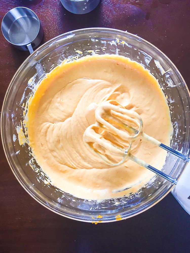 mixed pumpkin cheesecake batter in glass mixing bowl.