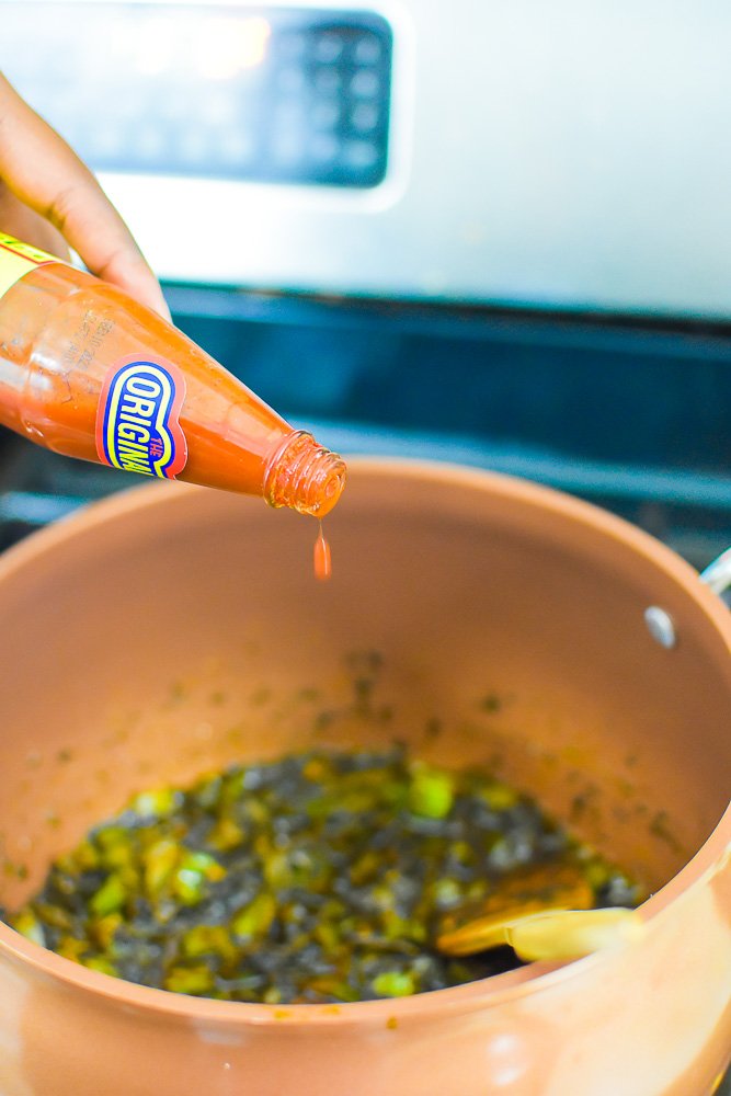 adding hot sauce to pot of dressing ingredients.