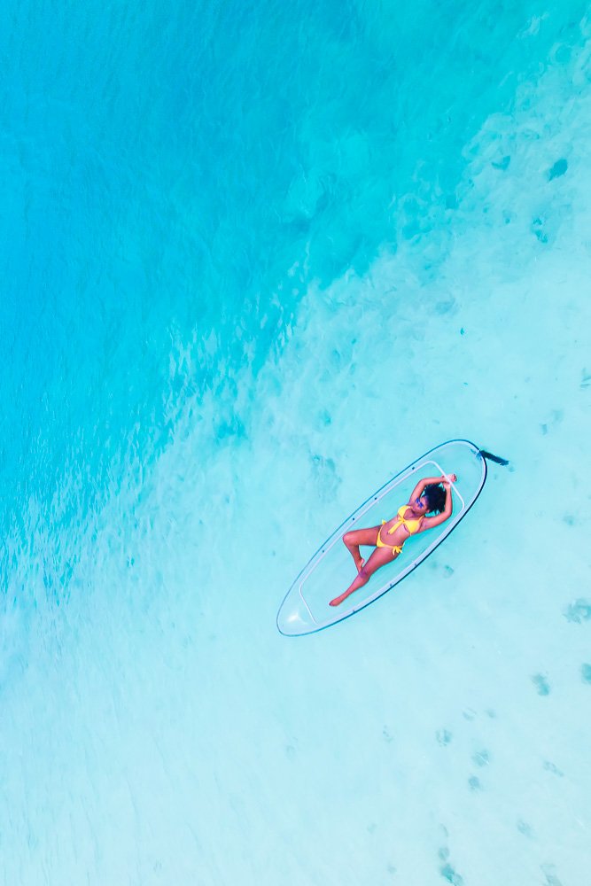 Jazzmine floating in clear kayak on Turks & Caicos water.