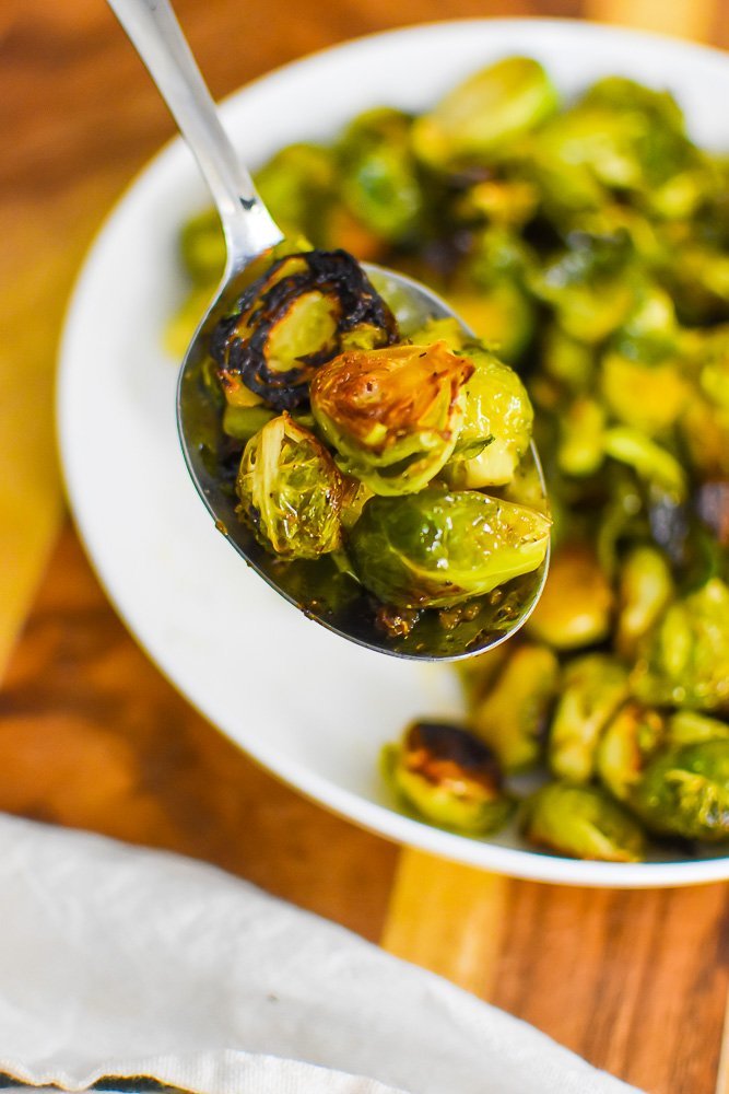 crispy brussels sprouts on serving spoon.