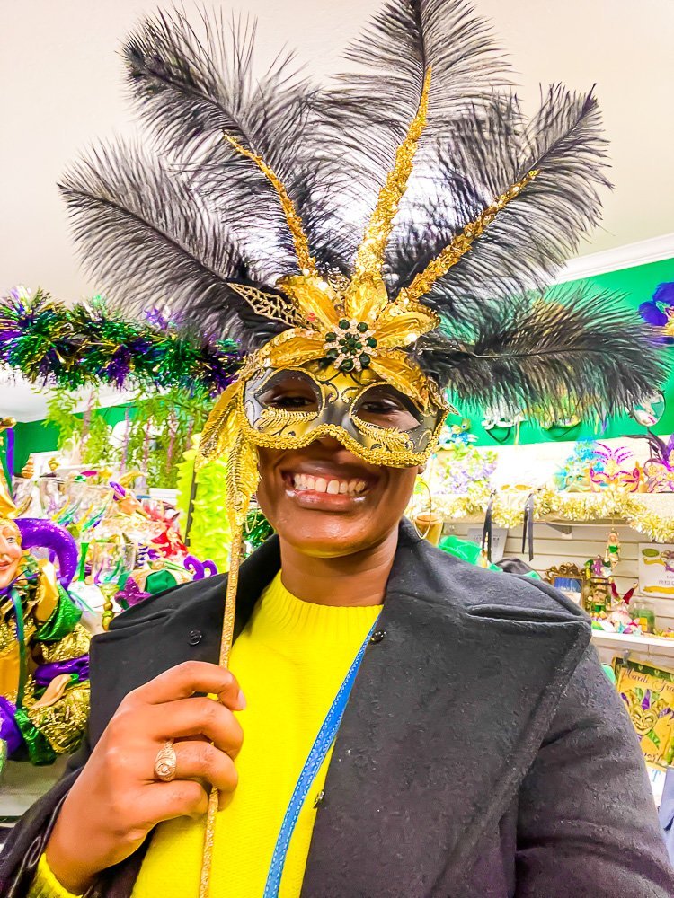 Jazzmine holding Mardi Gras mask at Enchanted Garden Shreveport.