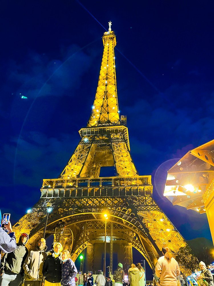 Eiffel Tower lit up at night.