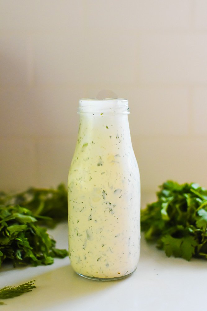 glass bottle of homemade dairy-free ranch dressing.