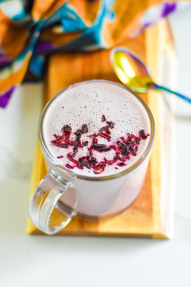 pink moon milk garnished with crushed hibiscus petals.