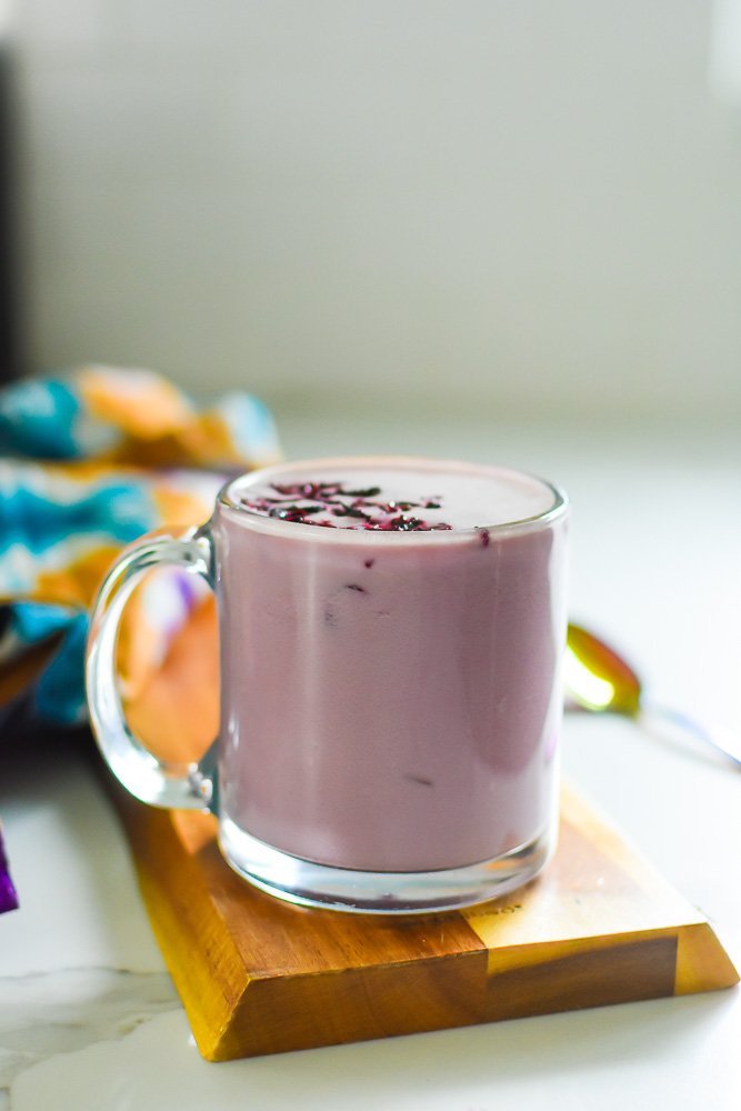 hot hibiscus pink drink latte in clear glass mug.