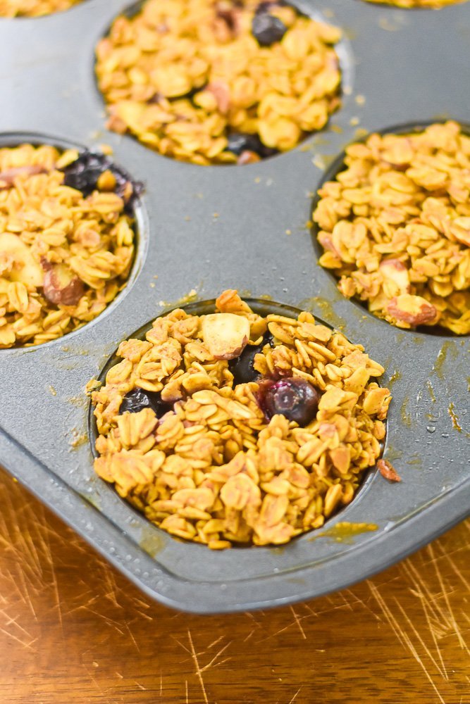 baked almond blueberry oatmeal muffins in nonstick pan.
