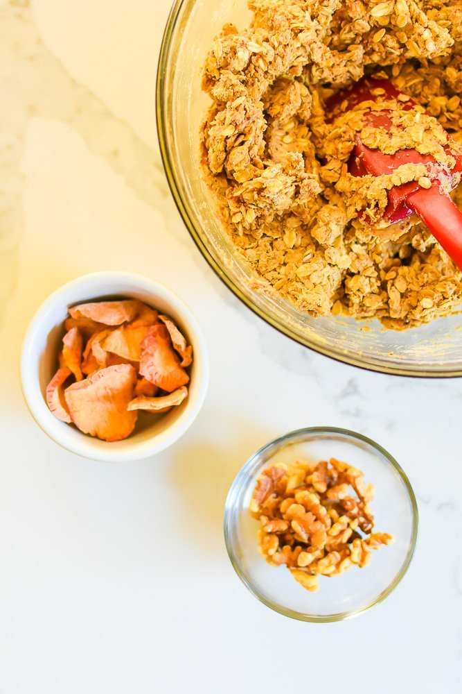 bowls of protein baked oatmeal mix, apple chips, and walnut pieces.