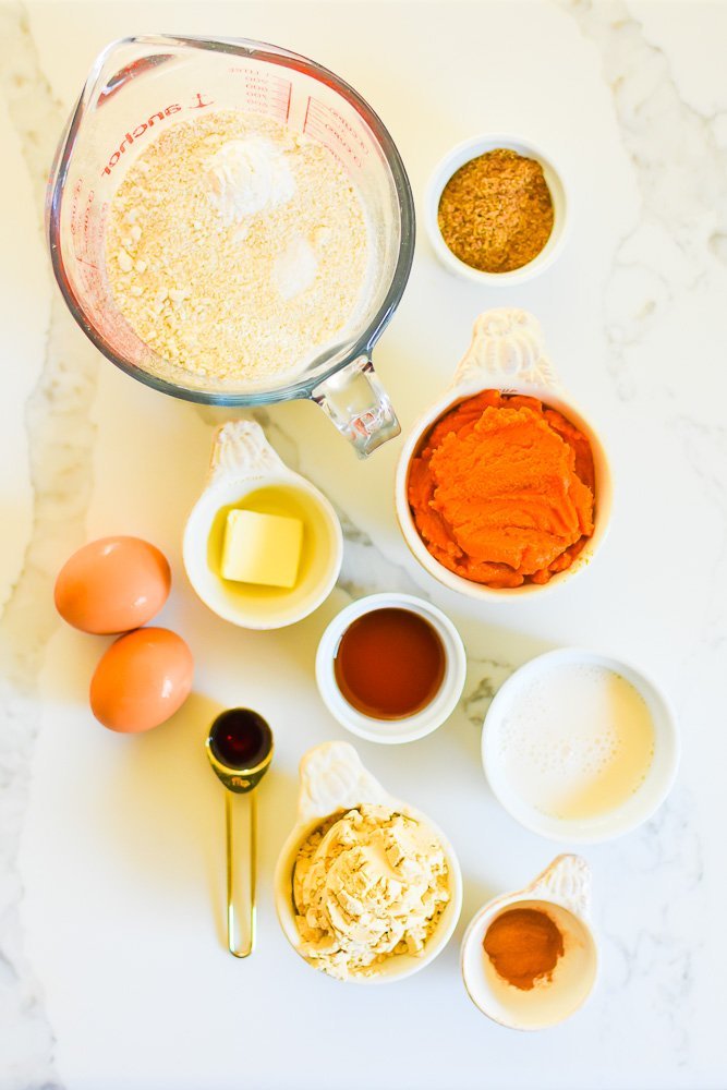 ingredients for pumpkin pancakes with protein on white granite counter top.