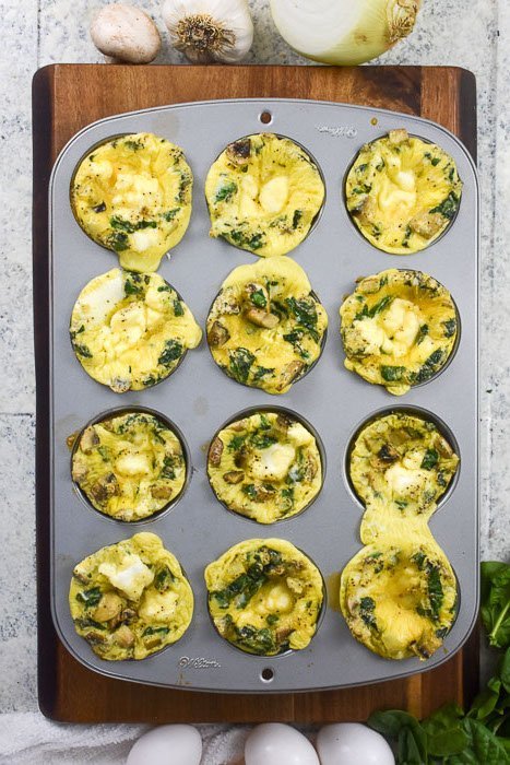 12 baked egg bites in a cupcake pan on kitchen counter top.