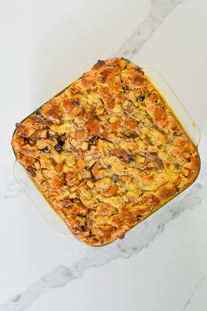 baked bread pudding in glass square pan.