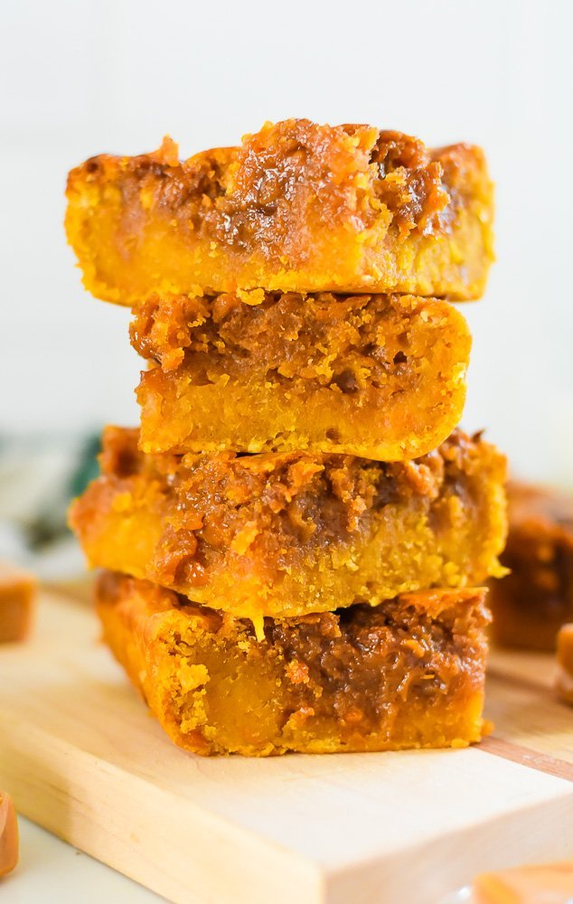 stack of four sweet potato blondie bars with gooey melted caramel.