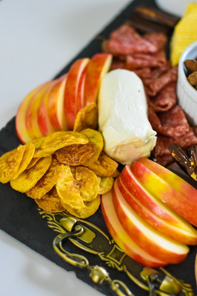 plantain chips, honeycrisp apple slices, and log of goat cheese on cheese tray.