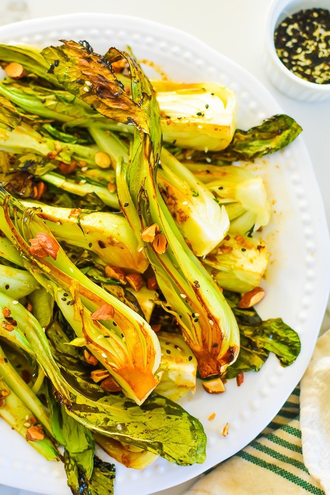 caramelized pieces of bok choy with crispy leaves topped with chopped almonds.