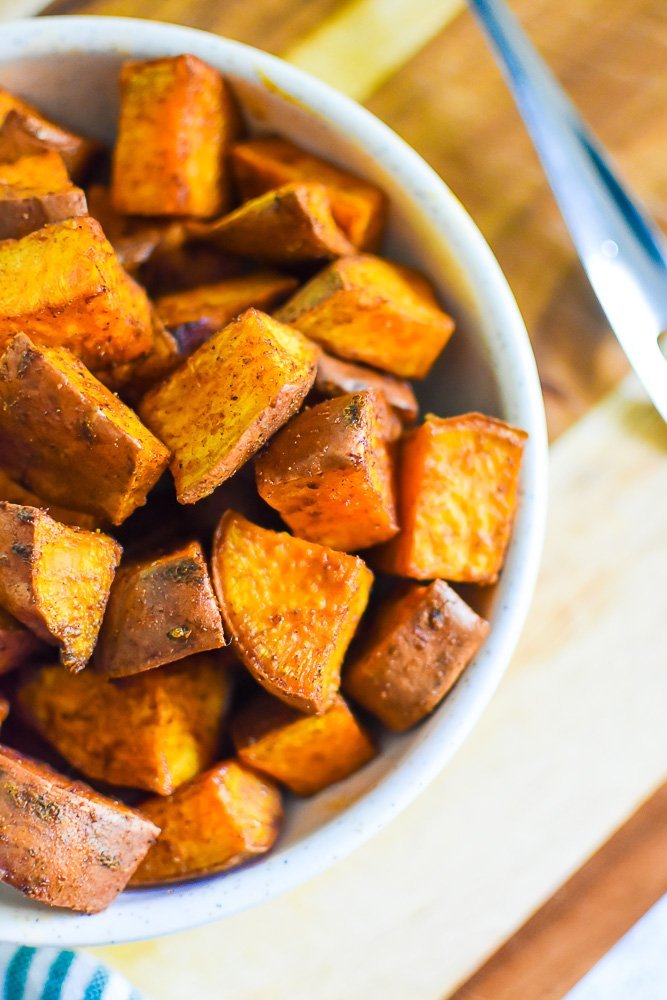 crispy roasted sweet potato pieces in a stone bowl.