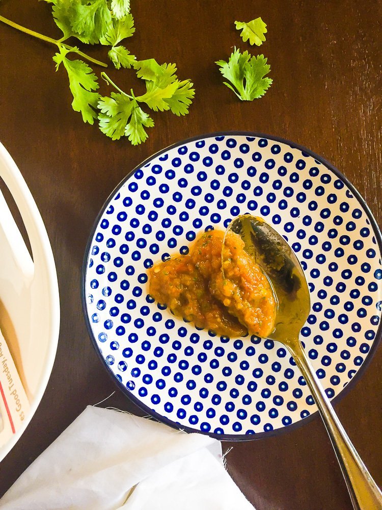 hatch pumpkin salsa on teaspoon on white and blue polka dot plate.
