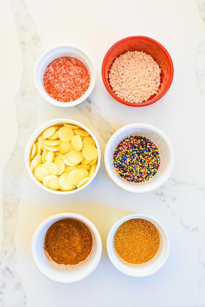 bowls of colorful sprinkles on counter top.
