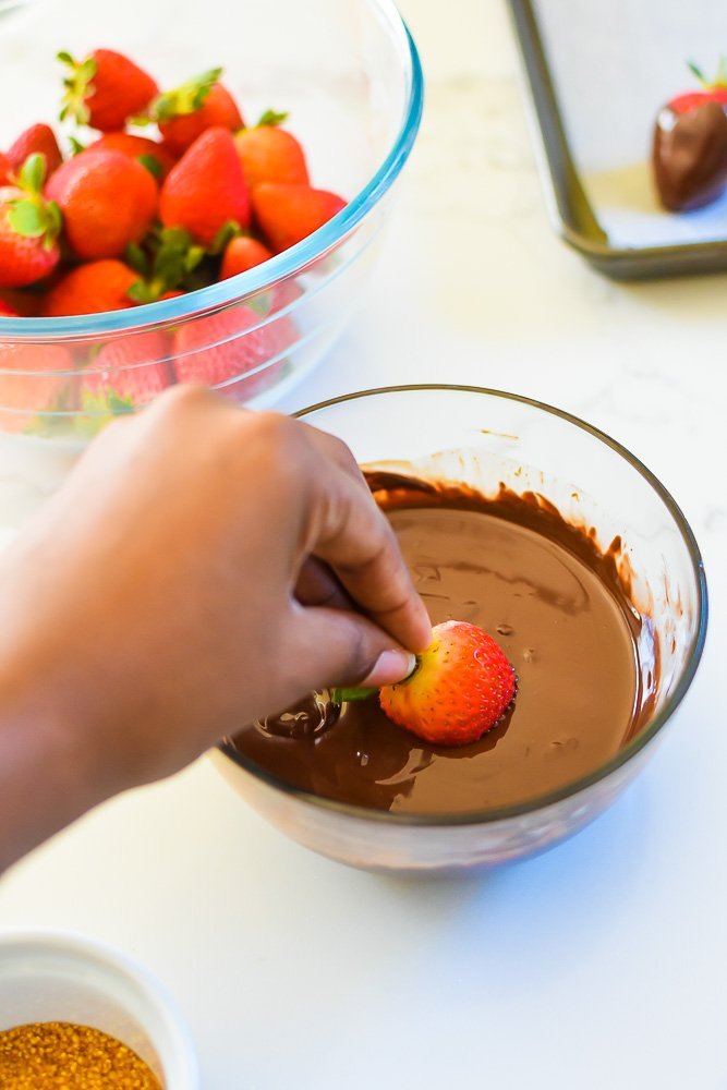 dipped fresh strawberry into melted chocolate at an angle for a professional look.