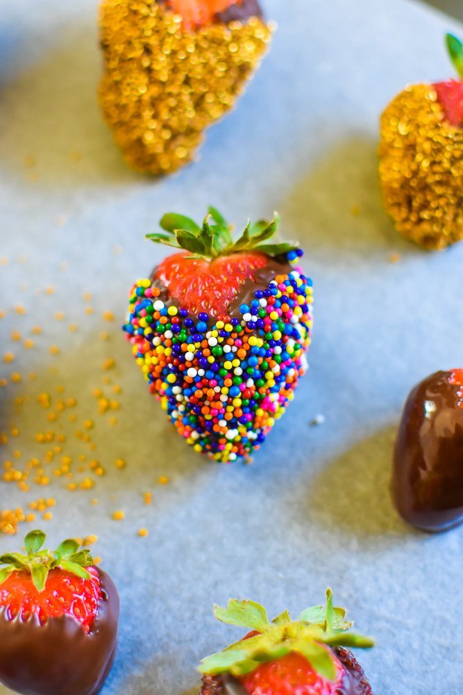 chocolate covered strawberry with rainbow sprinkles.