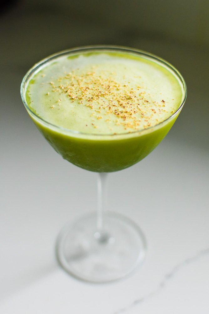 green tea martini made with gin and matcha in a coupe glass.