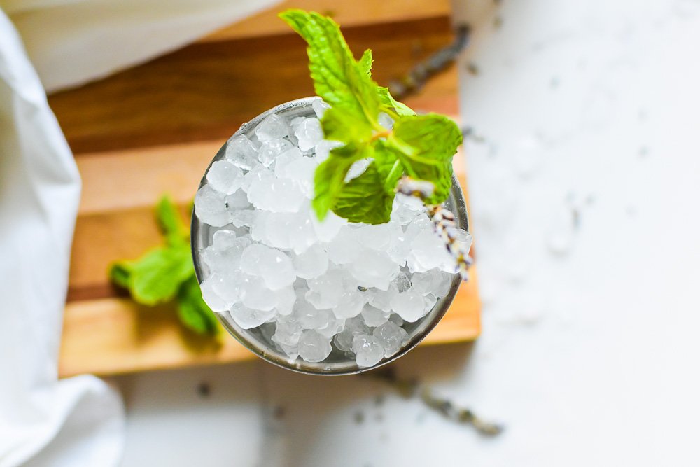 cobbled ice and fresh mint sprig on top of julep cocktail.