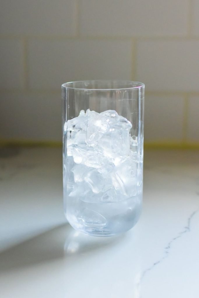 highball glass ¾ full with ice and three ounces gin.