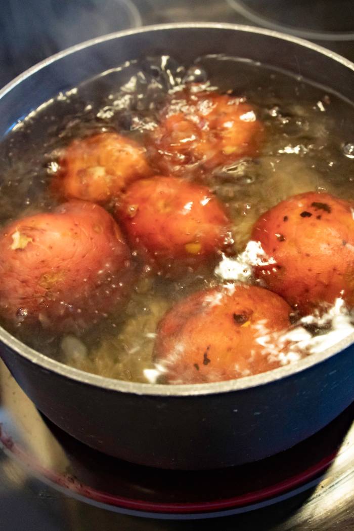 red skin potatoes in pot of boiling water.