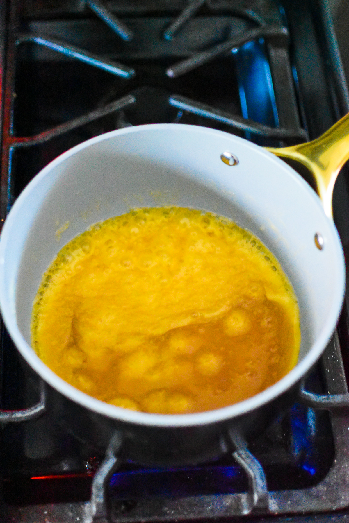 bubbling homemade praline sauce in small saucepan.