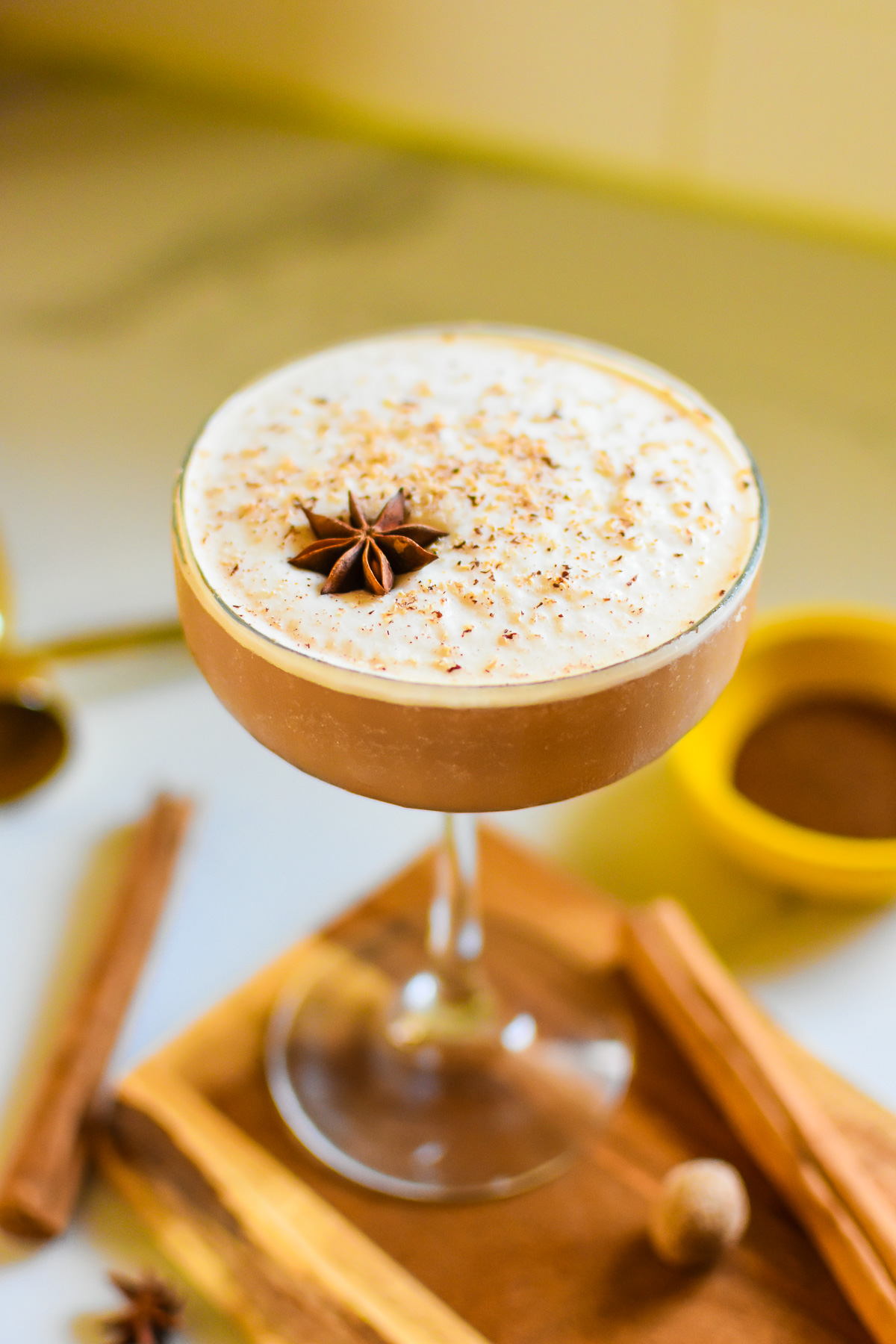 the best chai martini, aka chaitini cocktail in a frosty coupe glass garnished with freshly grated nutmeg and star anise.