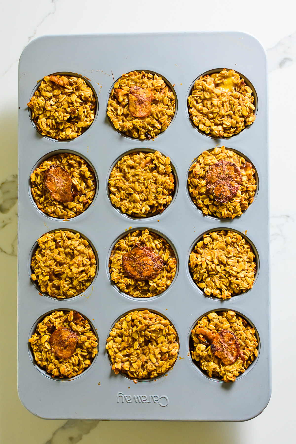 perfectly golden brown banana bread baked oatmeal cups in cupcake pan.