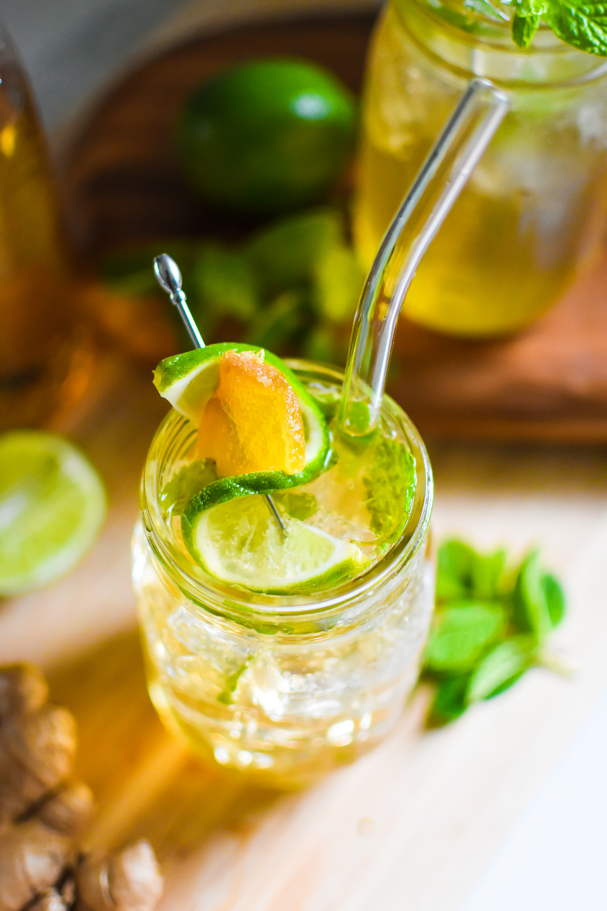the best ginger ale mocktail made with lime and mint flavors served in a mason jar glass sparkling over ice.