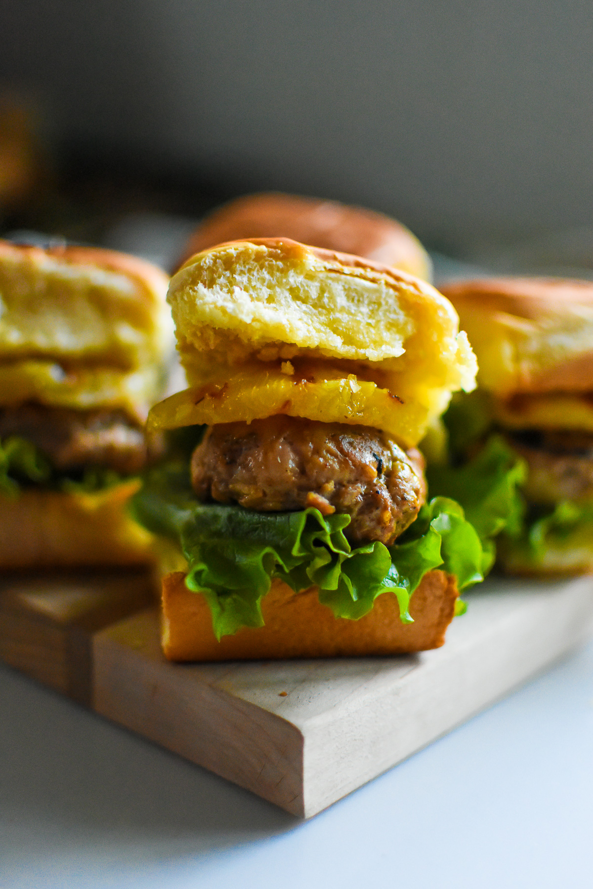 the best, juicy turkey burger sliders with grilled pineapple, and green leaf lettuce on buttery toasted King's Hawaiian rolls.